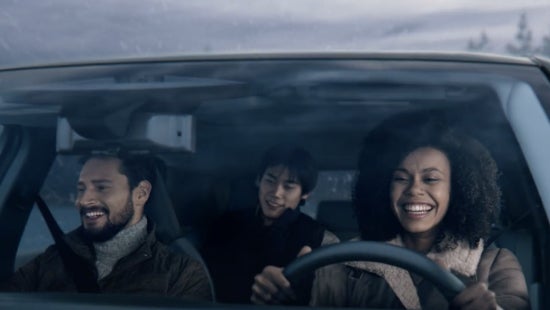 Three passengers riding in a vehicle and smiling | Pischke Motors Nissan in La Crosse WI